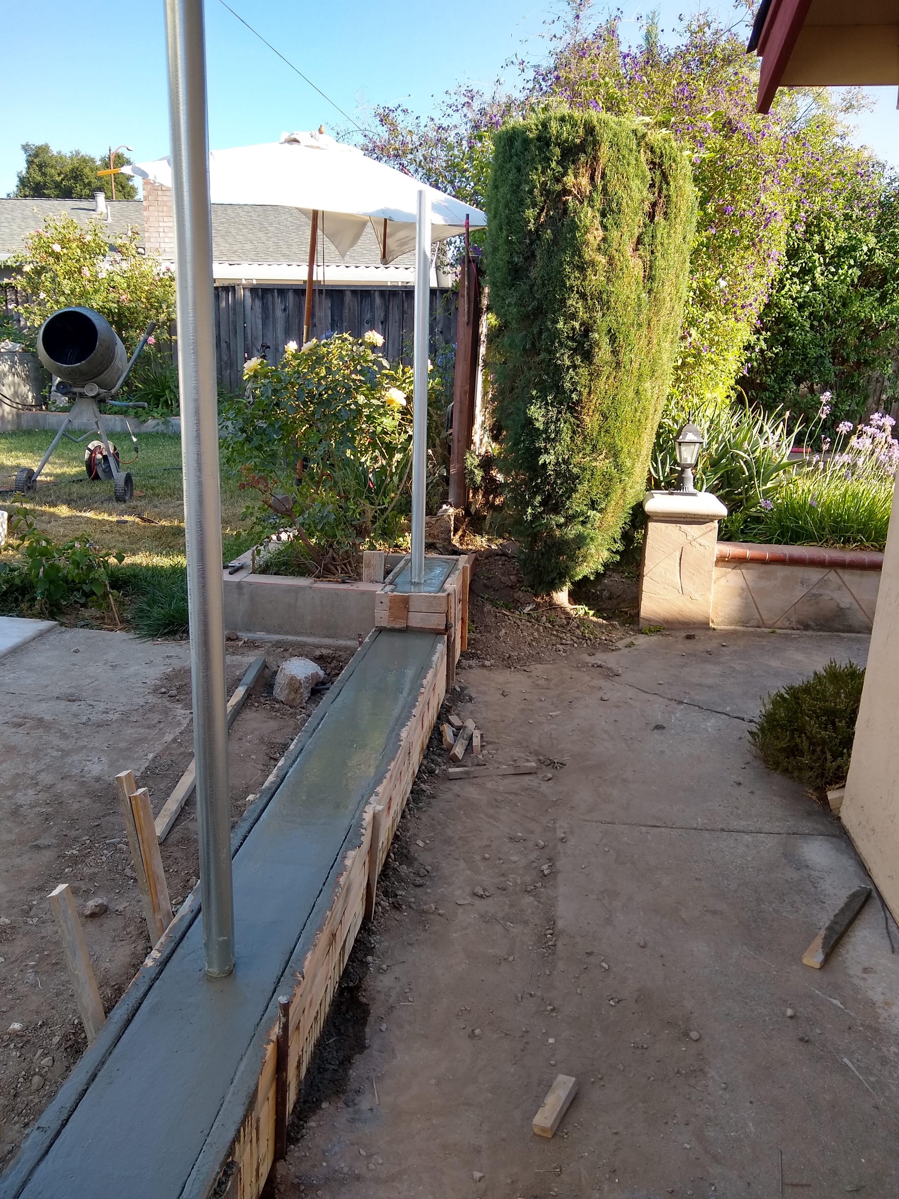 Steel posts with concrete footings ensure the wood never touches the ground